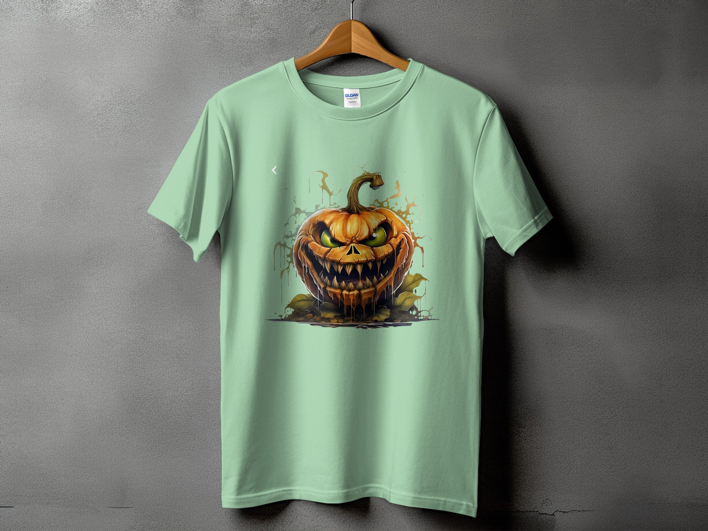 Mint green t-shirt with a spooky carved jack-o'-lantern Halloween graphic.