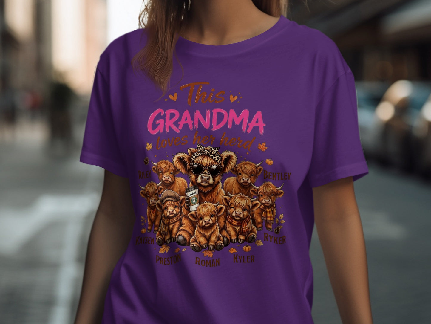 Purple t-shirt with "This Grandma loves her herd" and illustrated highland cows.