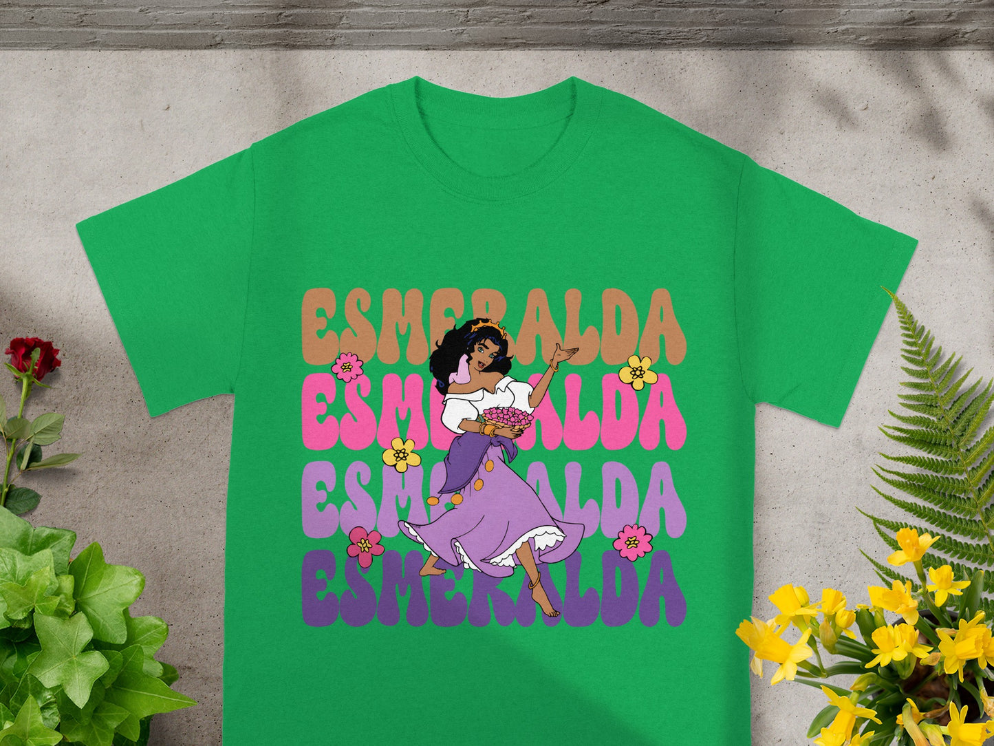Esmeralda dancing in purple dress with colorful text on a green t-shirt.