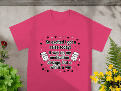 Pink t-shirt with text "So excited I got a raise today! It was on my medication dosage, but a win is a win."
