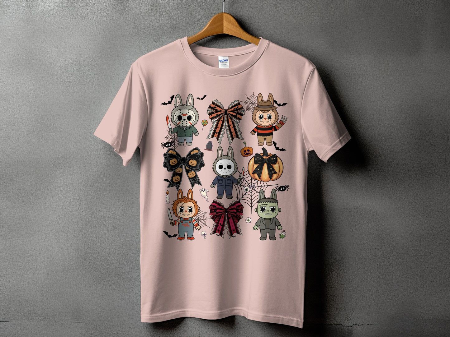 Pink t-shirt with Halloween horror characters and bows graphic print.