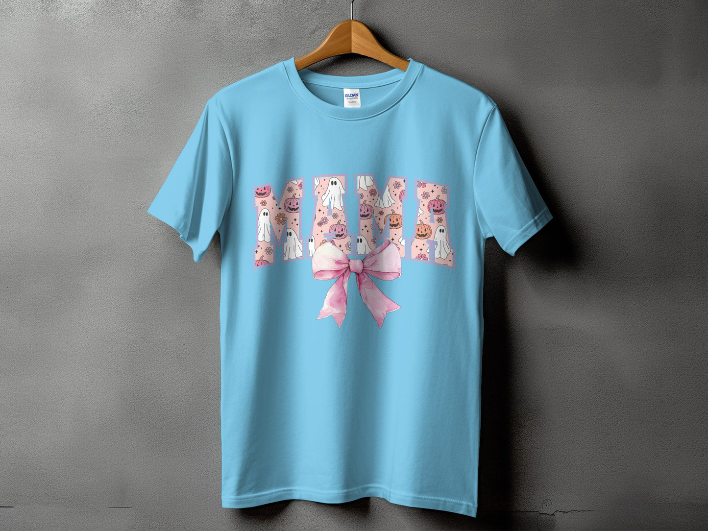 Light blue t-shirt with "MAMA" text filled with ghosts, pumpkins, and flowers.