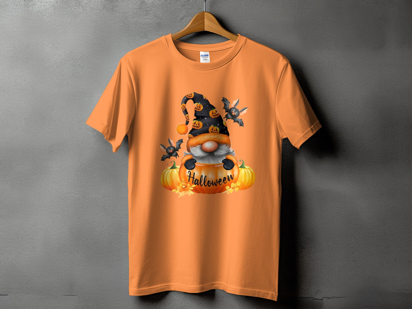 Orange t-shirt with Halloween gnome, bats, and pumpkins graphic.