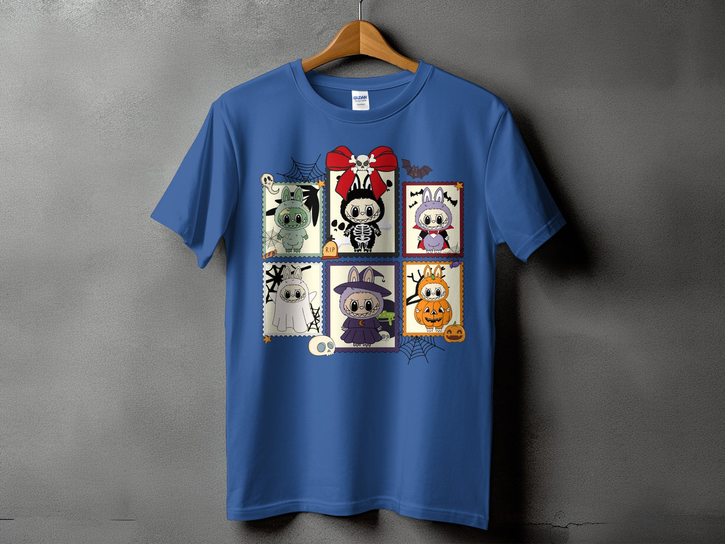 Blue t-shirt with a grid of six Halloween-themed stamps featuring cute characters.