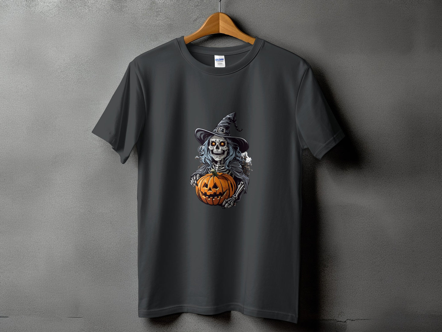 Dark grey t-shirt with a skeleton wearing a witch hat holding a pumpkin.