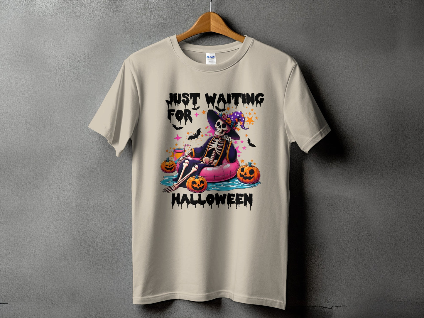 Skeleton floating with pumpkins, text "JUST WAITING FOR HALLOWEEN".