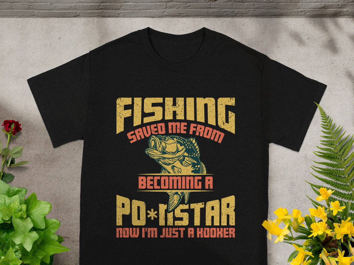 Black t-shirt with "Fishing saved me from becoming a po*star now I'm just a hooker" text.