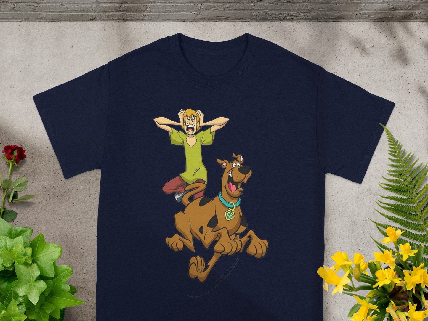 Scooby-Doo and Shaggy running in front of a dark blue t-shirt.