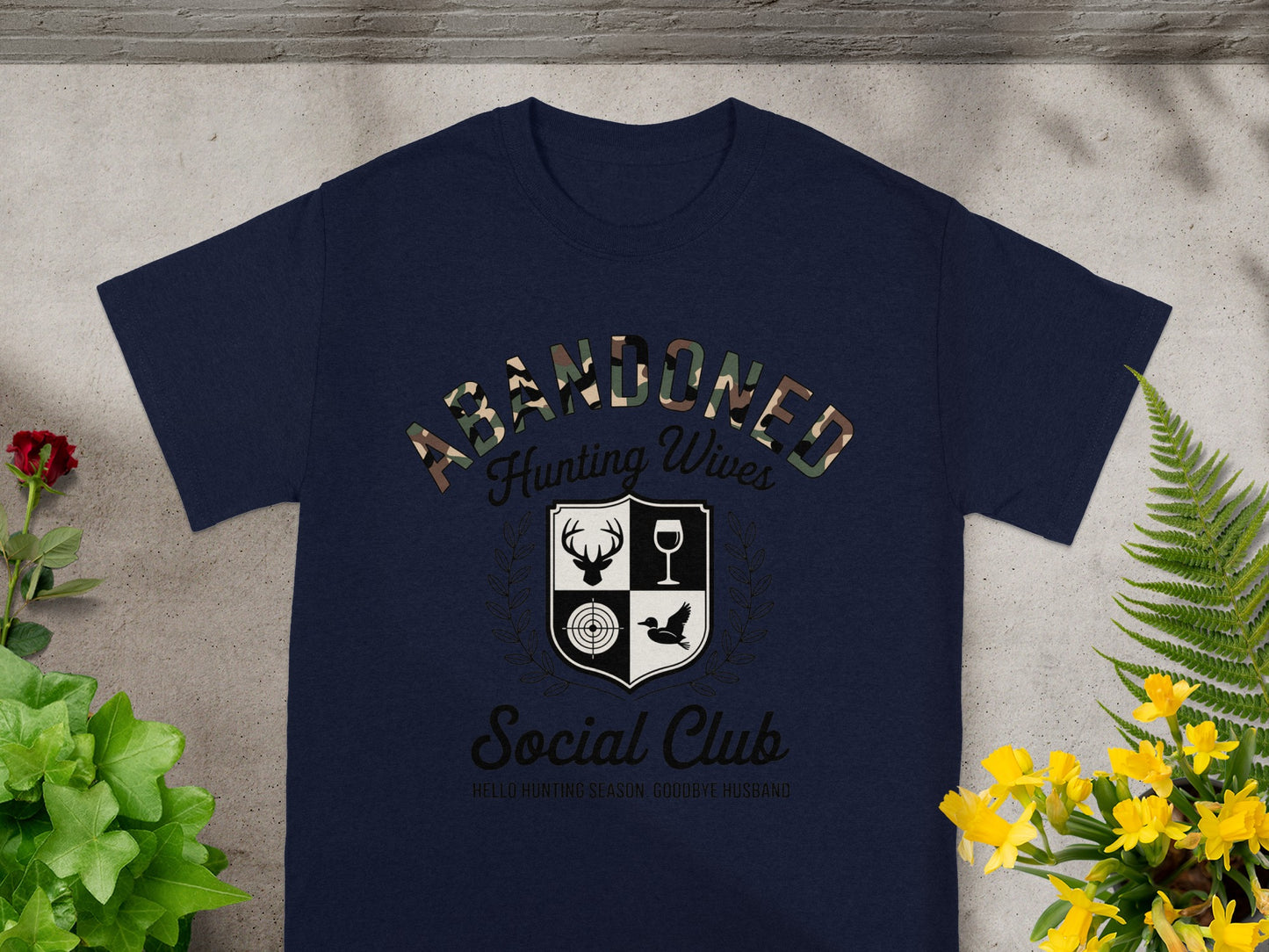 Navy t-shirt with "Abandoned Hunting Wives Social Club" and hunting-themed crest.