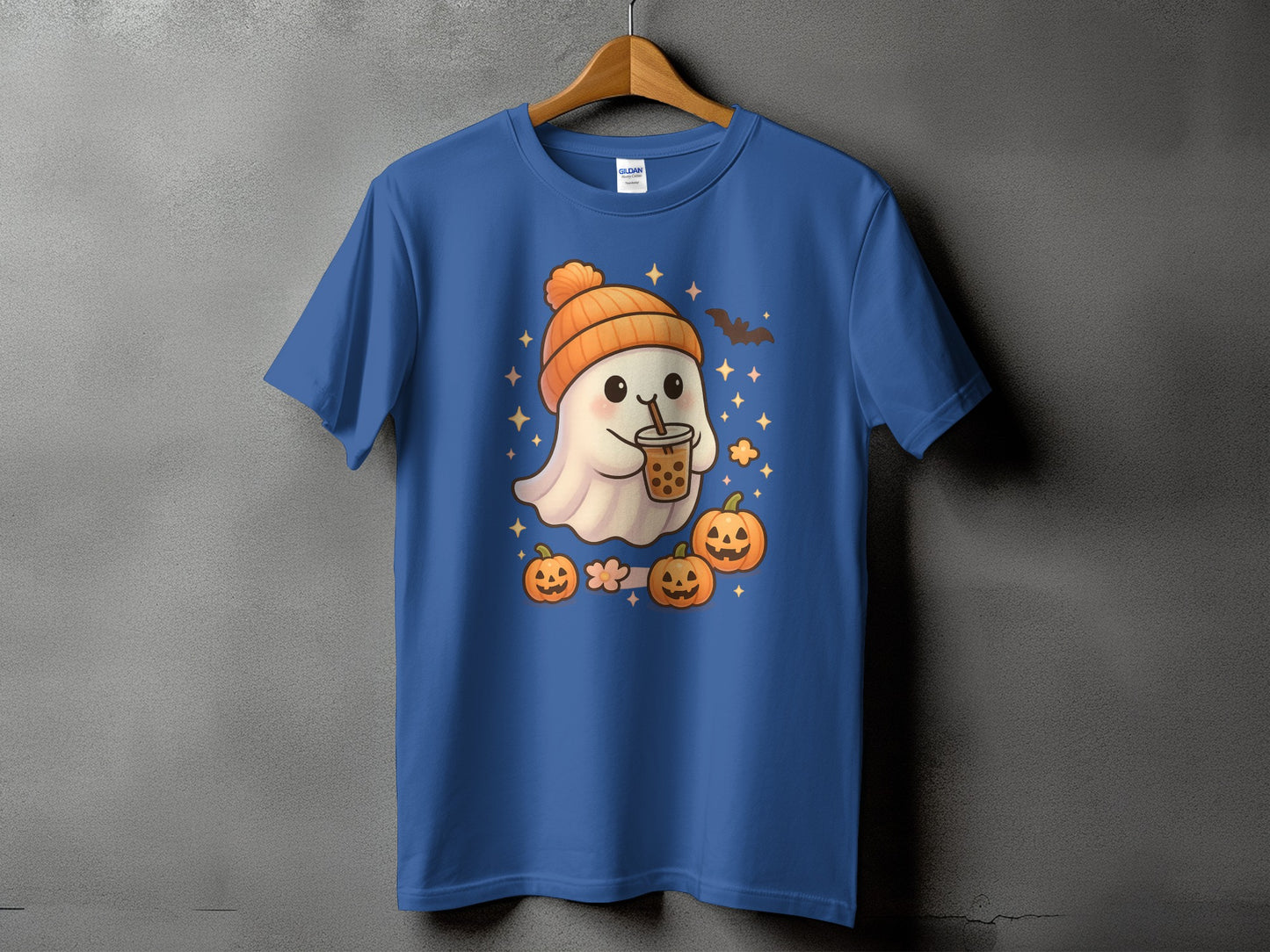 Blue t-shirt with a cute ghost wearing an orange beanie holding bubble tea, surrounded by pumpkins.