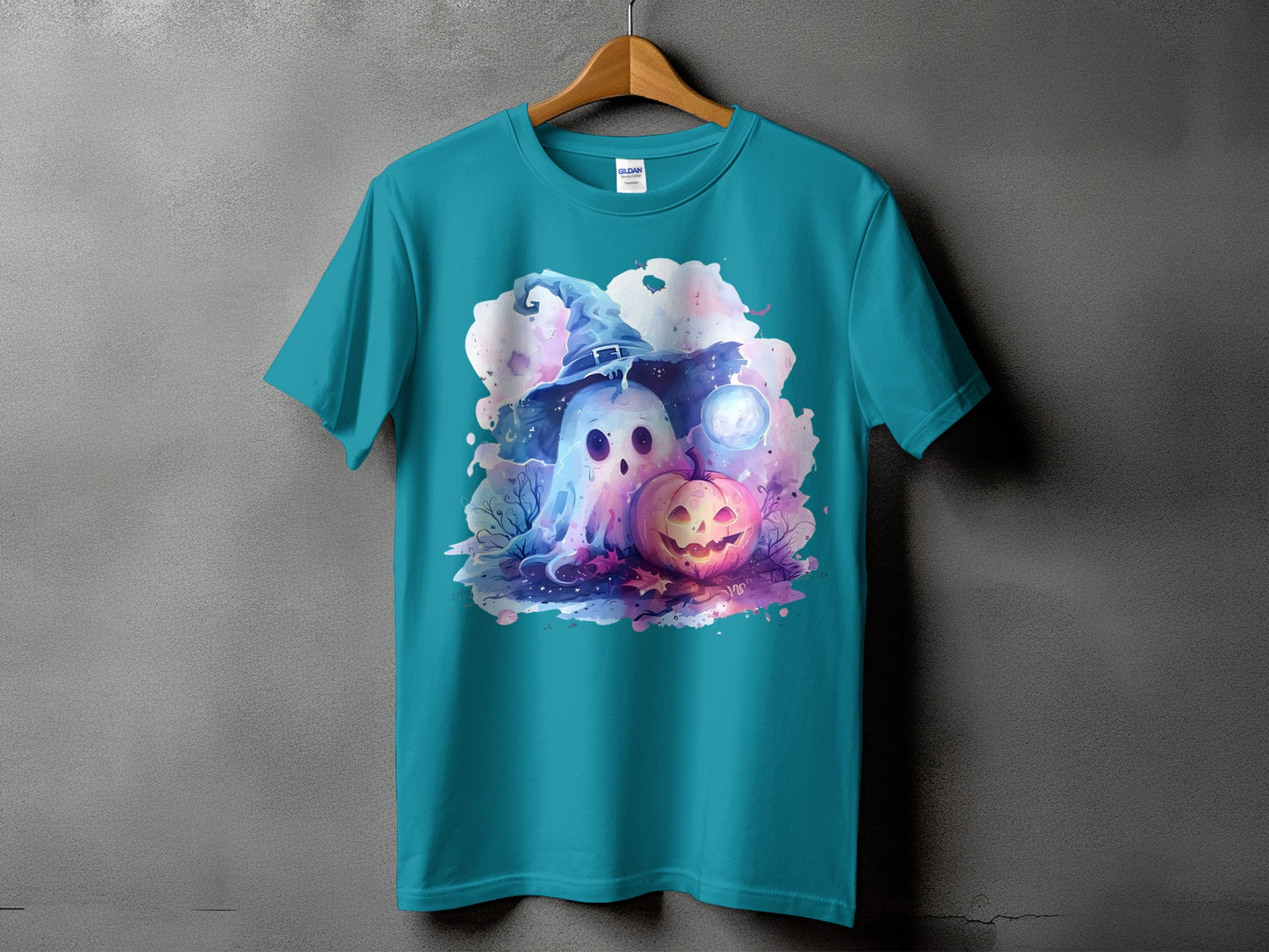 Teal t-shirt featuring a watercolor ghost in a witch hat and jack-o'-lantern.