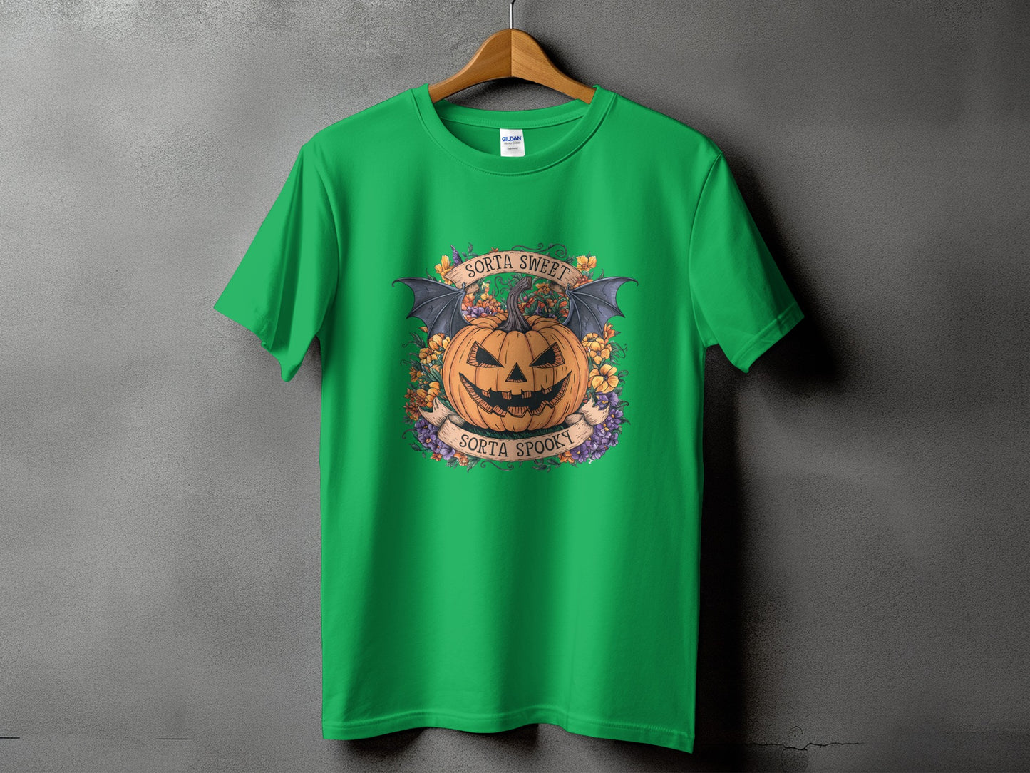Green t-shirt with a jack-o'-lantern, bat wings, flowers, and text "Sorta Sweet Sorta Spooky".