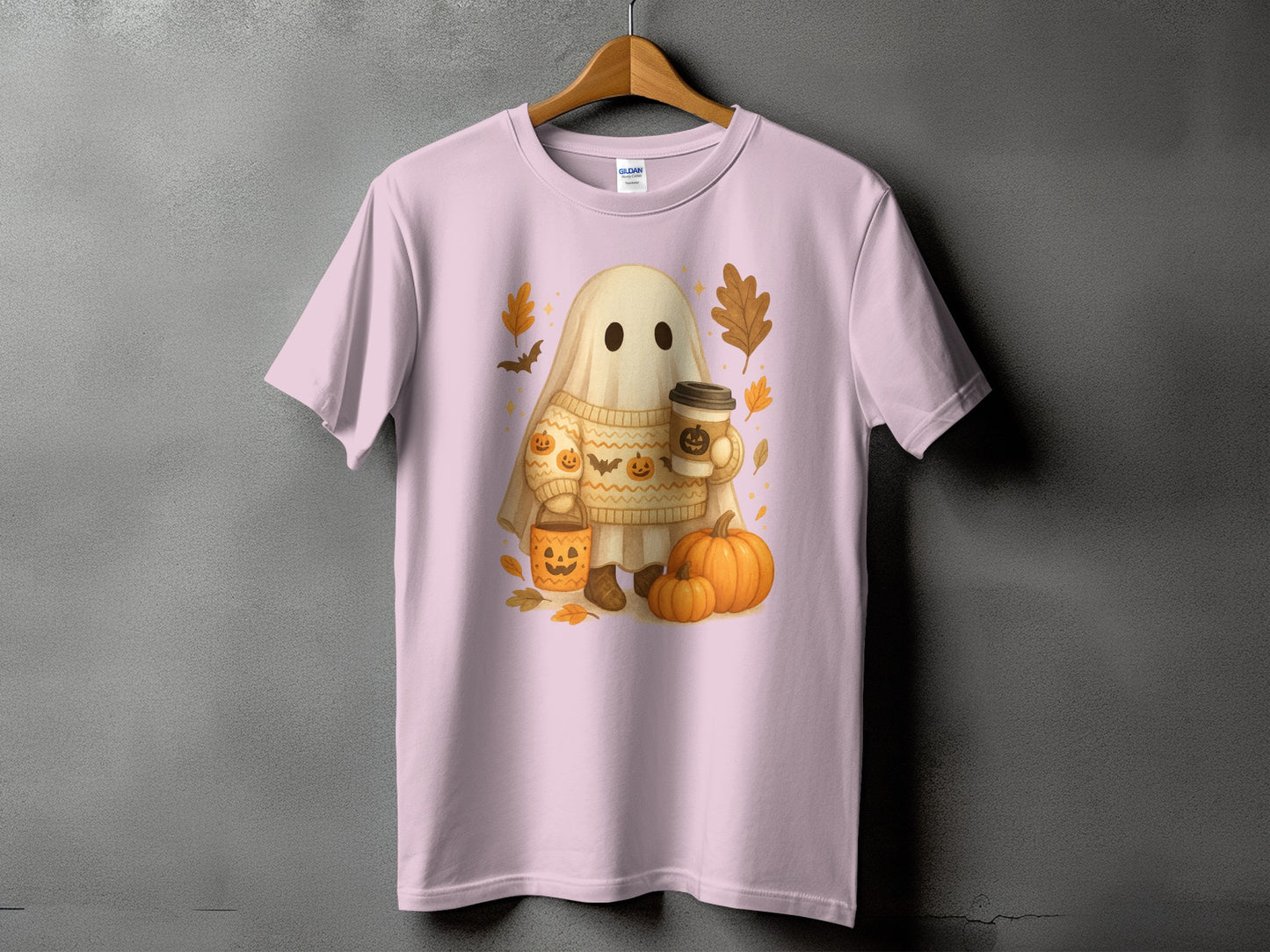 Pink t-shirt with watercolor graphic of a ghost holding coffee and candy bucket.