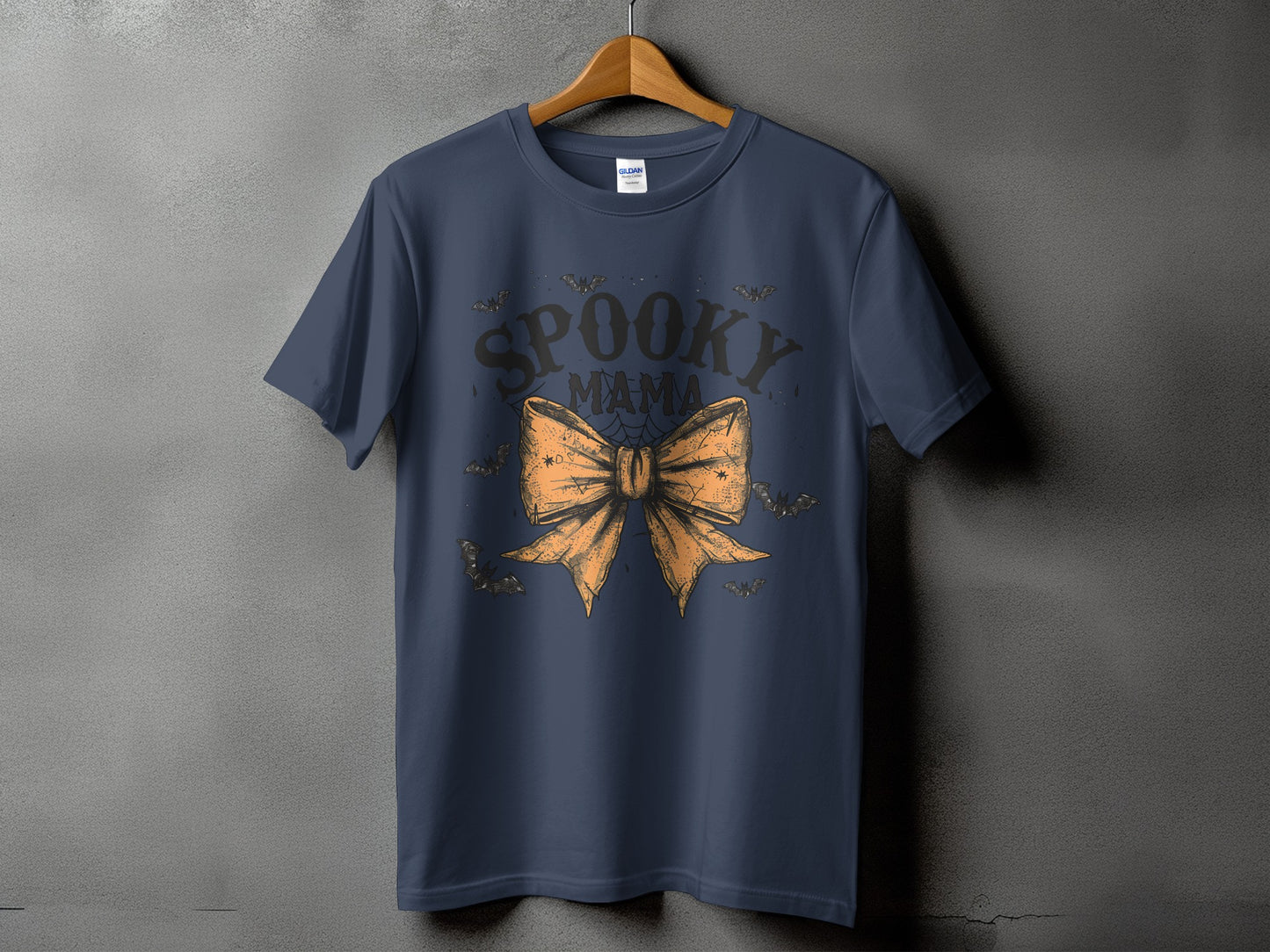 Navy t-shirt with "Spooky Mama" text and orange bow graphic.