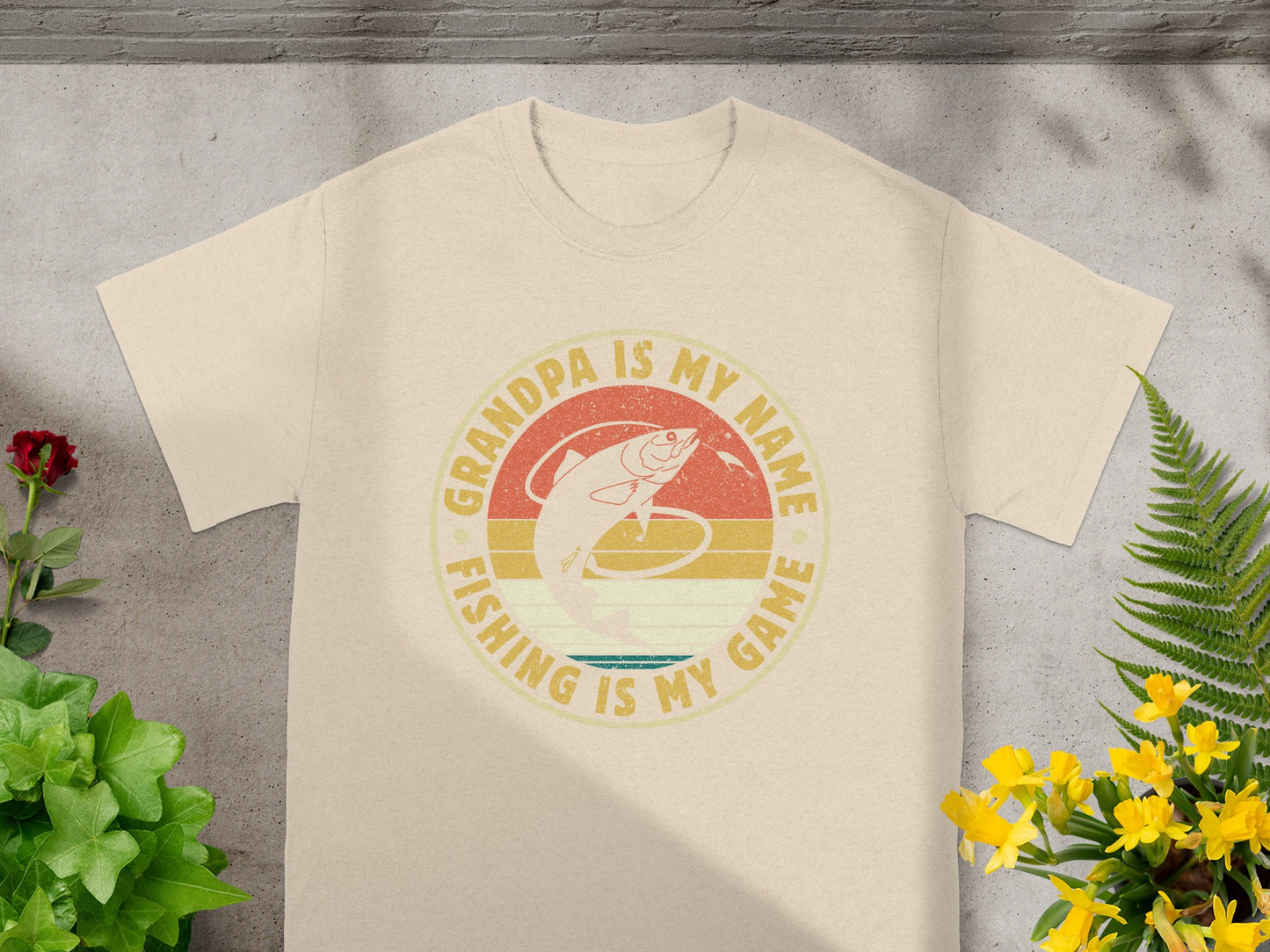 Light beige t-shirt with a circular graphic containing text and a fish.