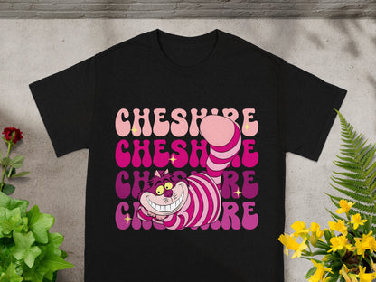 Black t-shirt with gradient "Cheshire" text and cartoon Cheshire Cat graphic.