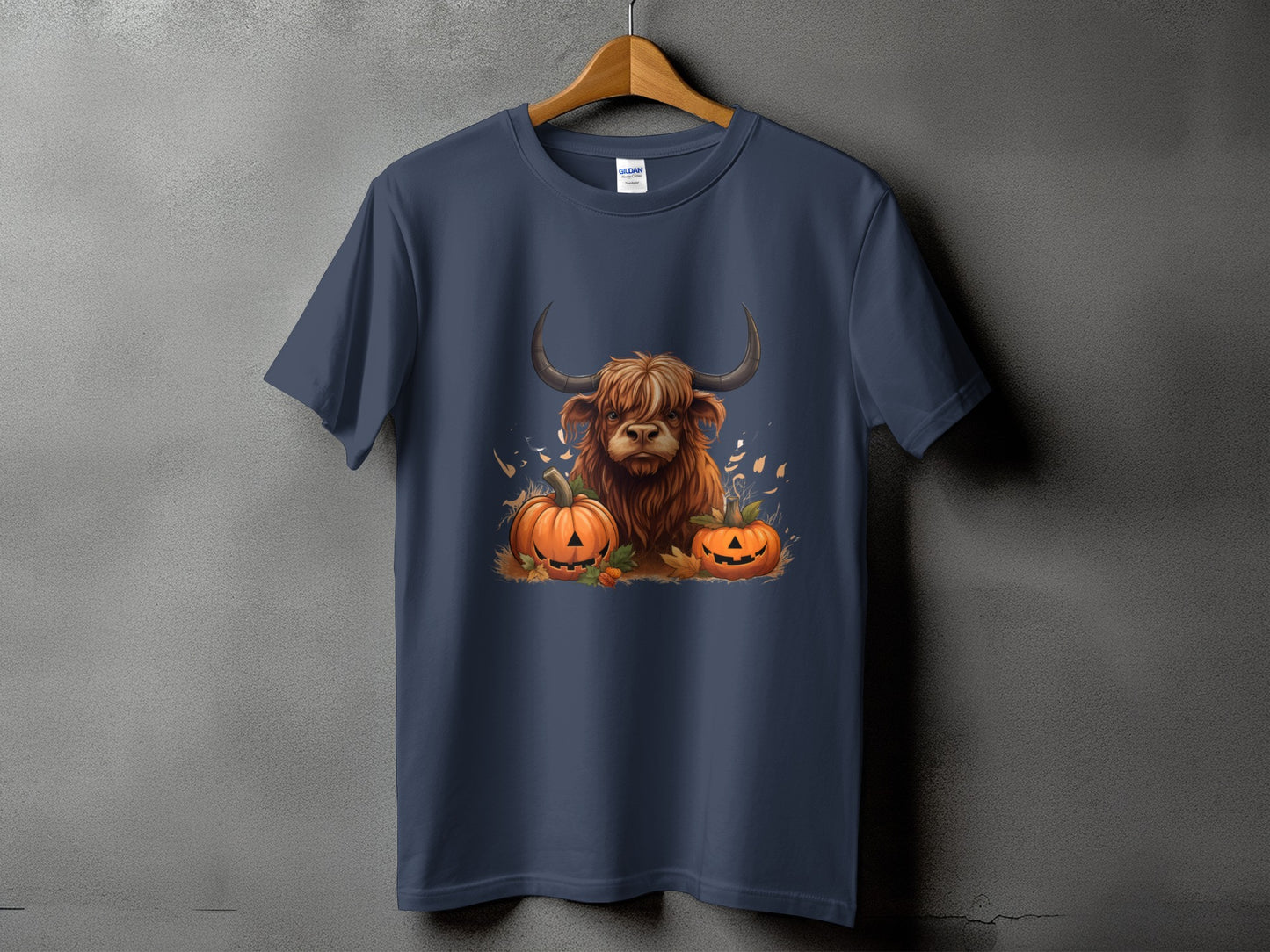 Navy t-shirt with a Highland cow and two jack-o'-lanterns graphic.