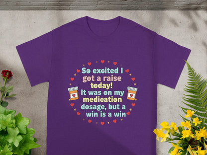 Purple t-shirt with text "So excited I got a raise today! It was on my medication dosage, but a win is a win."