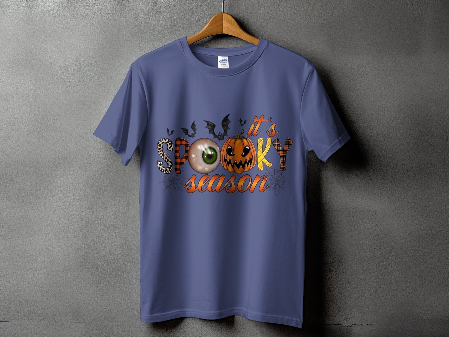 Purple t-shirt with "it's spooky season" text featuring Halloween graphics.