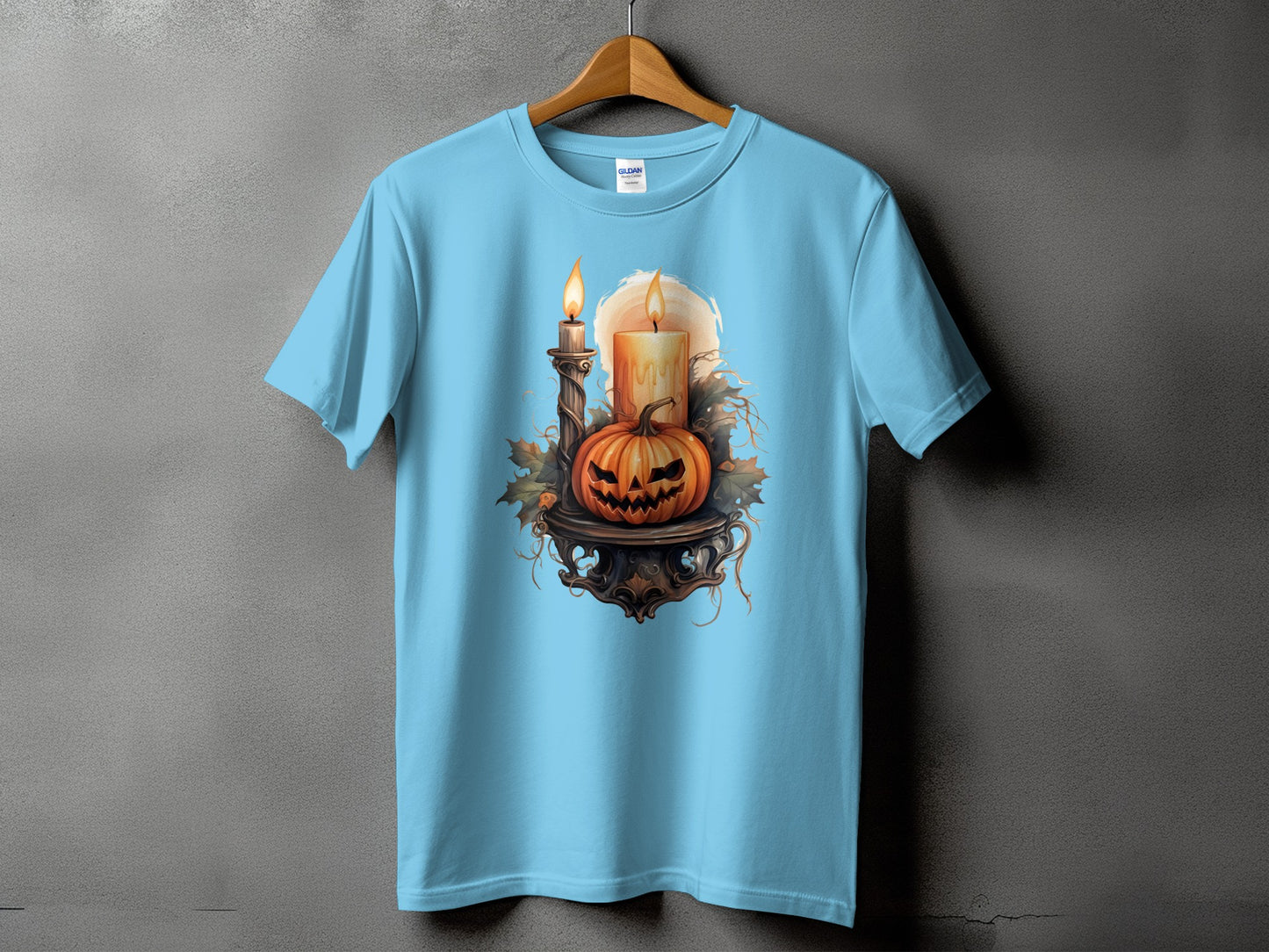 Light blue t-shirt with a Halloween graphic of a jack-o'-lantern and candles.