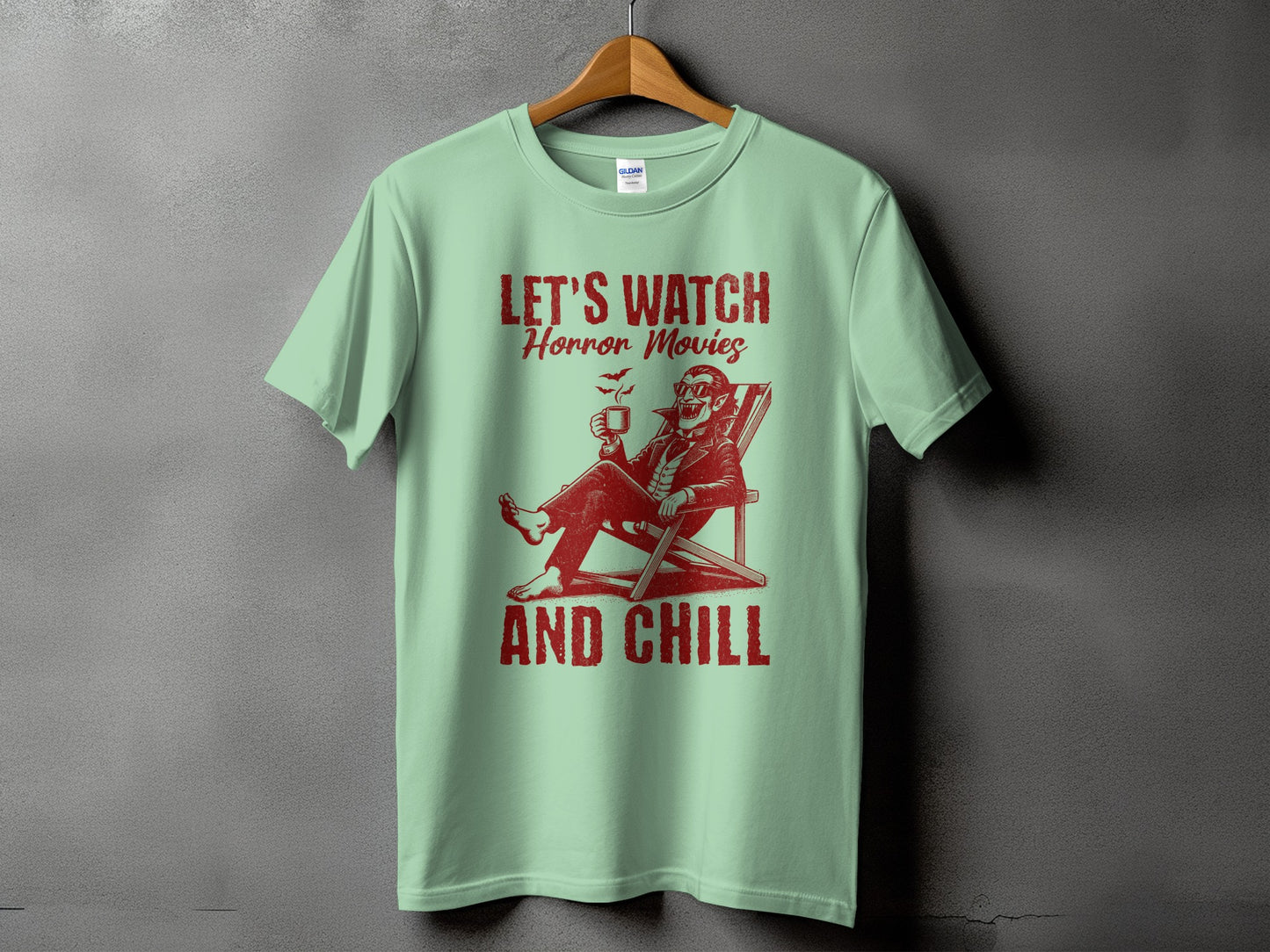 Mint t-shirt with red graphic text "LET'S WATCH Horror Movies AND CHILL" and vampire illustration.