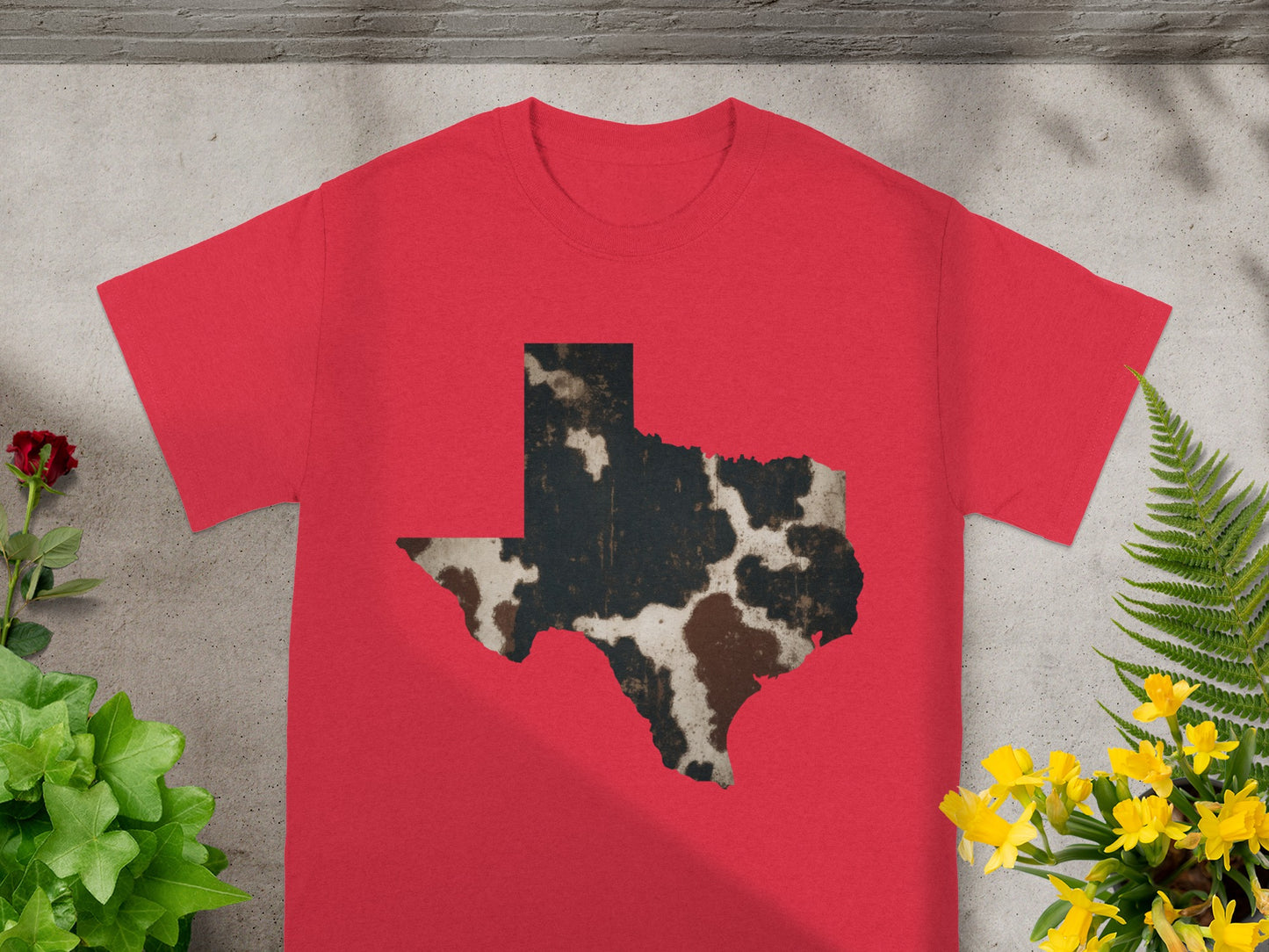 Red t-shirt with a muted cowhide pattern Texas silhouette design.