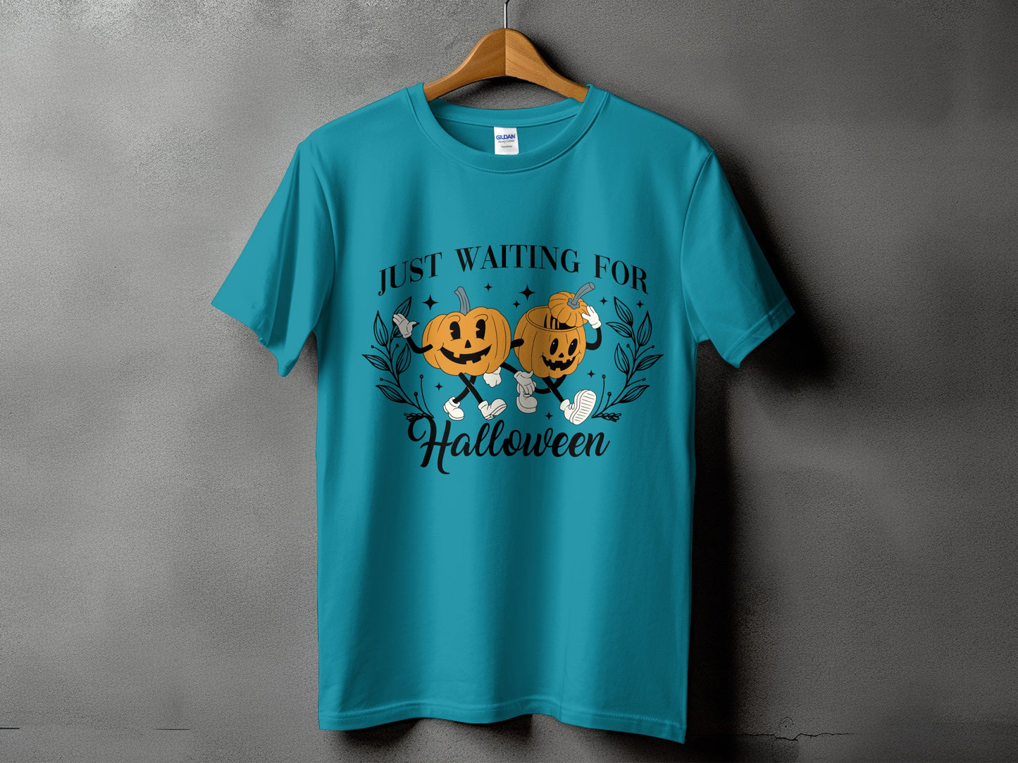 Teal t-shirt with pumpkins and text "JUST WAITING FOR Halloween".
