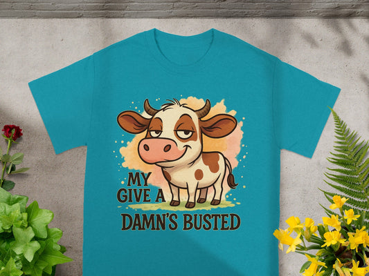 Turquoise t-shirt with cartoon cow and "MY DAMN'S BUSTED" text.