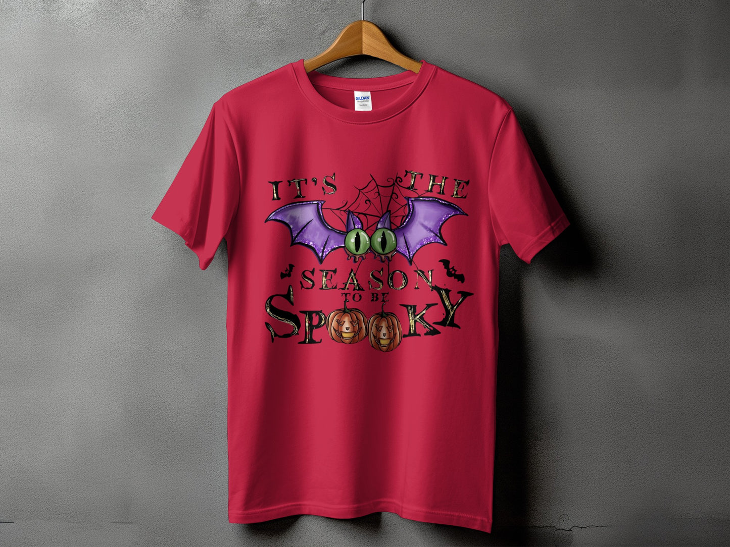 Red t-shirt with "It's The Season To Be Spooky" Halloween graphic.
