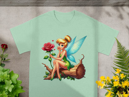 Fairy in green dress sitting on a log with a rose.