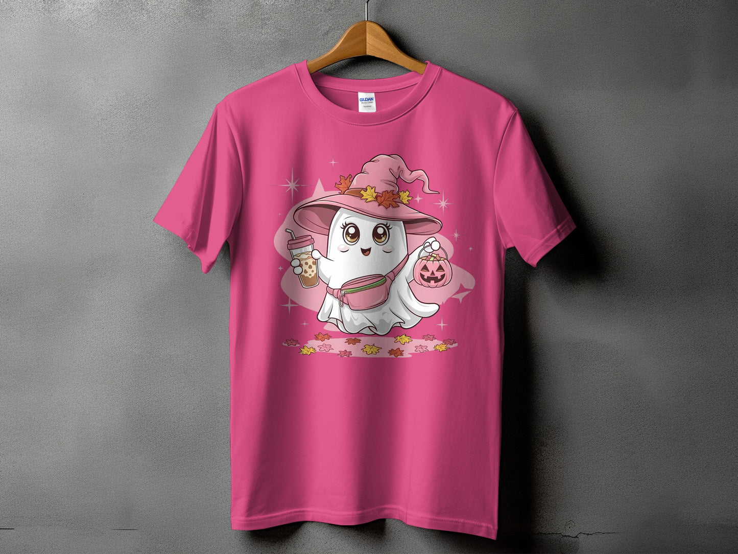 Pink t-shirt with a cartoon ghost wearing a witch hat, holding bubble tea and a pumpkin.