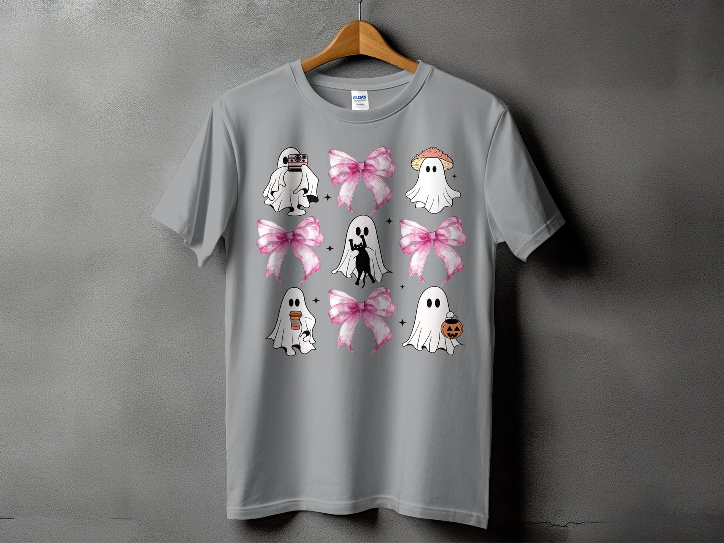 Grey t-shirt with a nine-panel graphic featuring ghosts, pink bows, a cat, and Halloween icons.