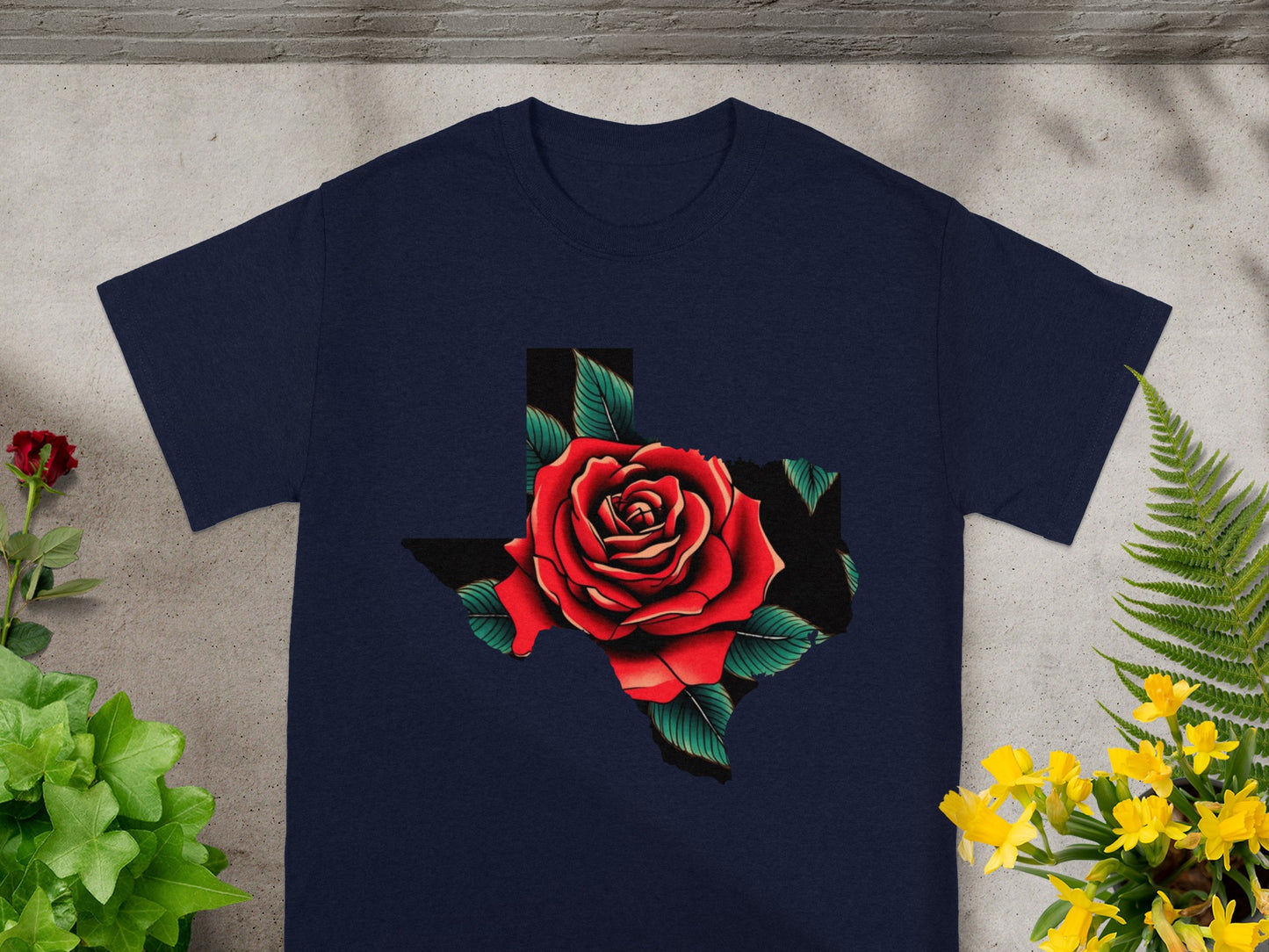 Navy t-shirt with a Texas shape filled with a red rose and green leaves.