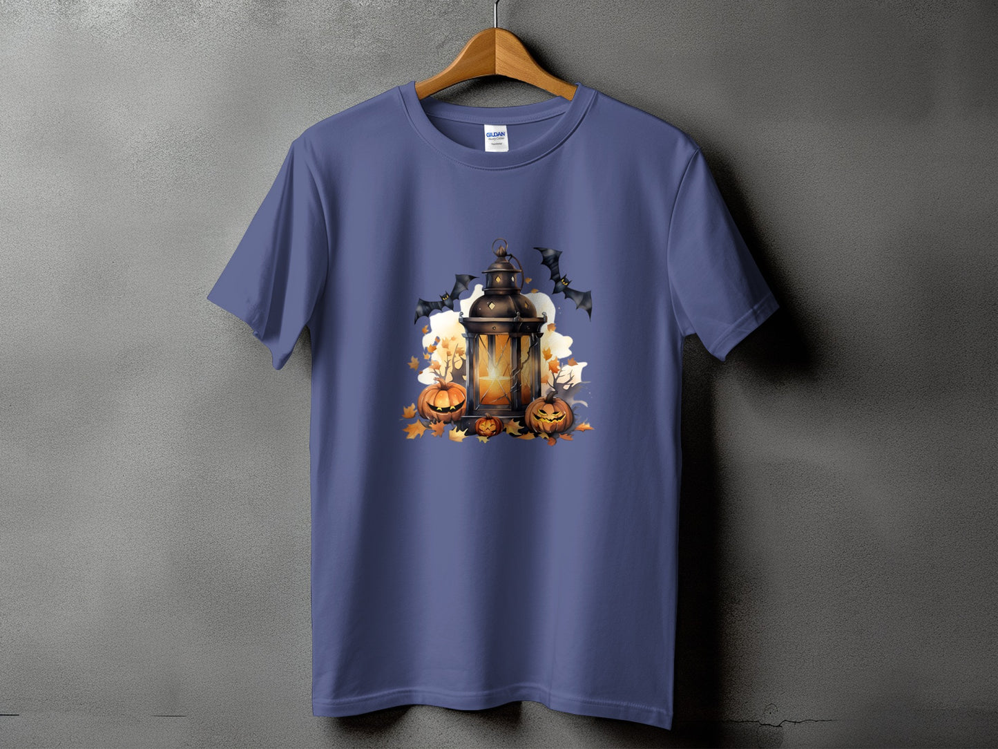 Halloween lantern with pumpkins, bats, and autumn leaves graphic on a purple t-shirt.