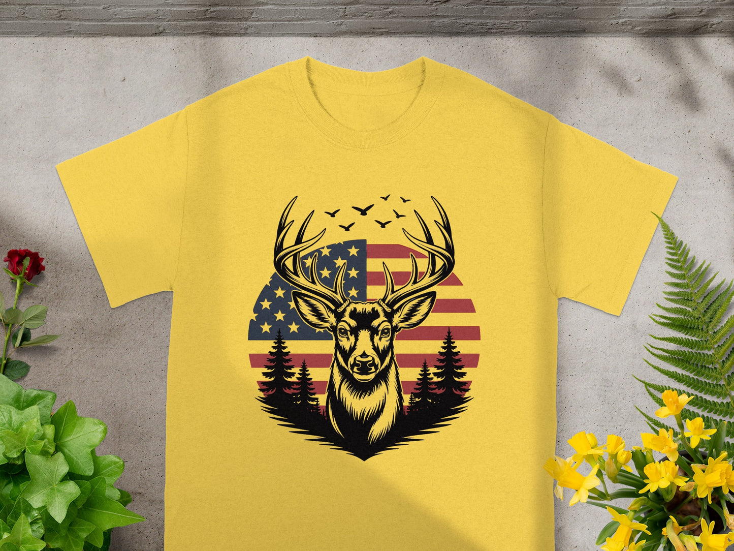 Yellow t-shirt featuring a deer, American flag, and pine trees graphic.