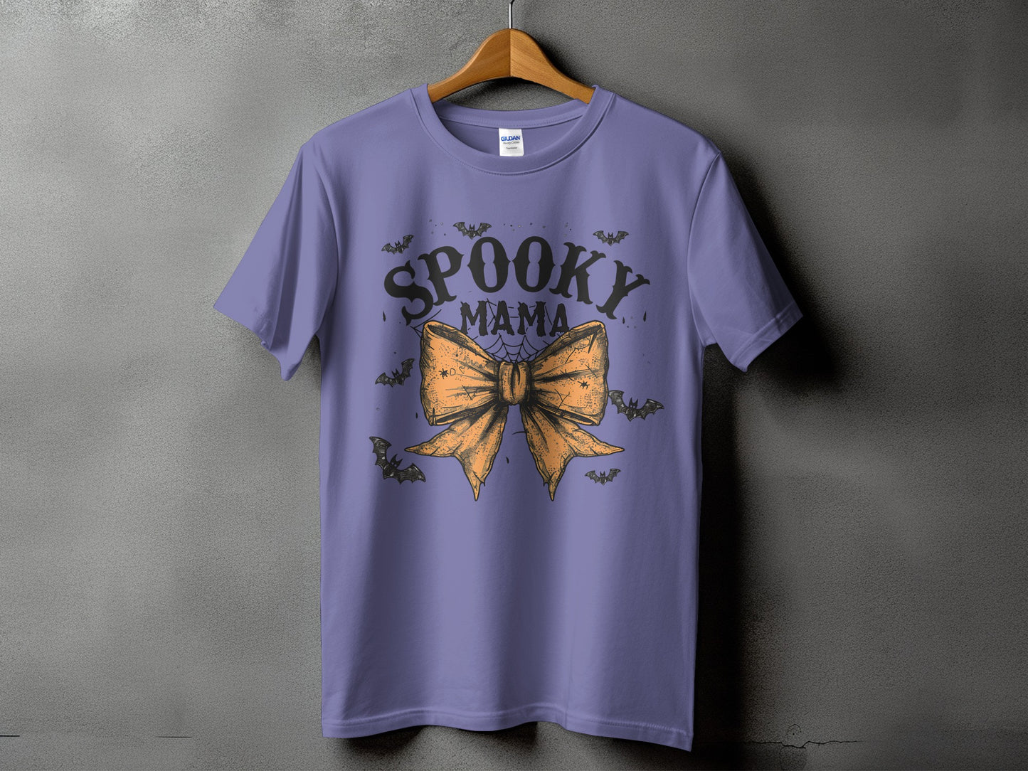Purple t-shirt with "Spooky Mama" text, bow, and bats graphic.