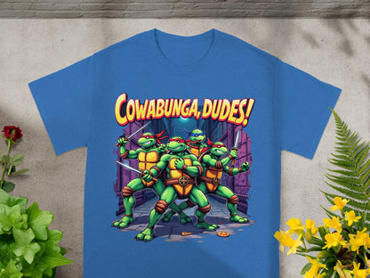 Teenage Mutant Ninja Turtles stand ready with swords on a blue shirt with "Cowabunga, Dudes!" text.