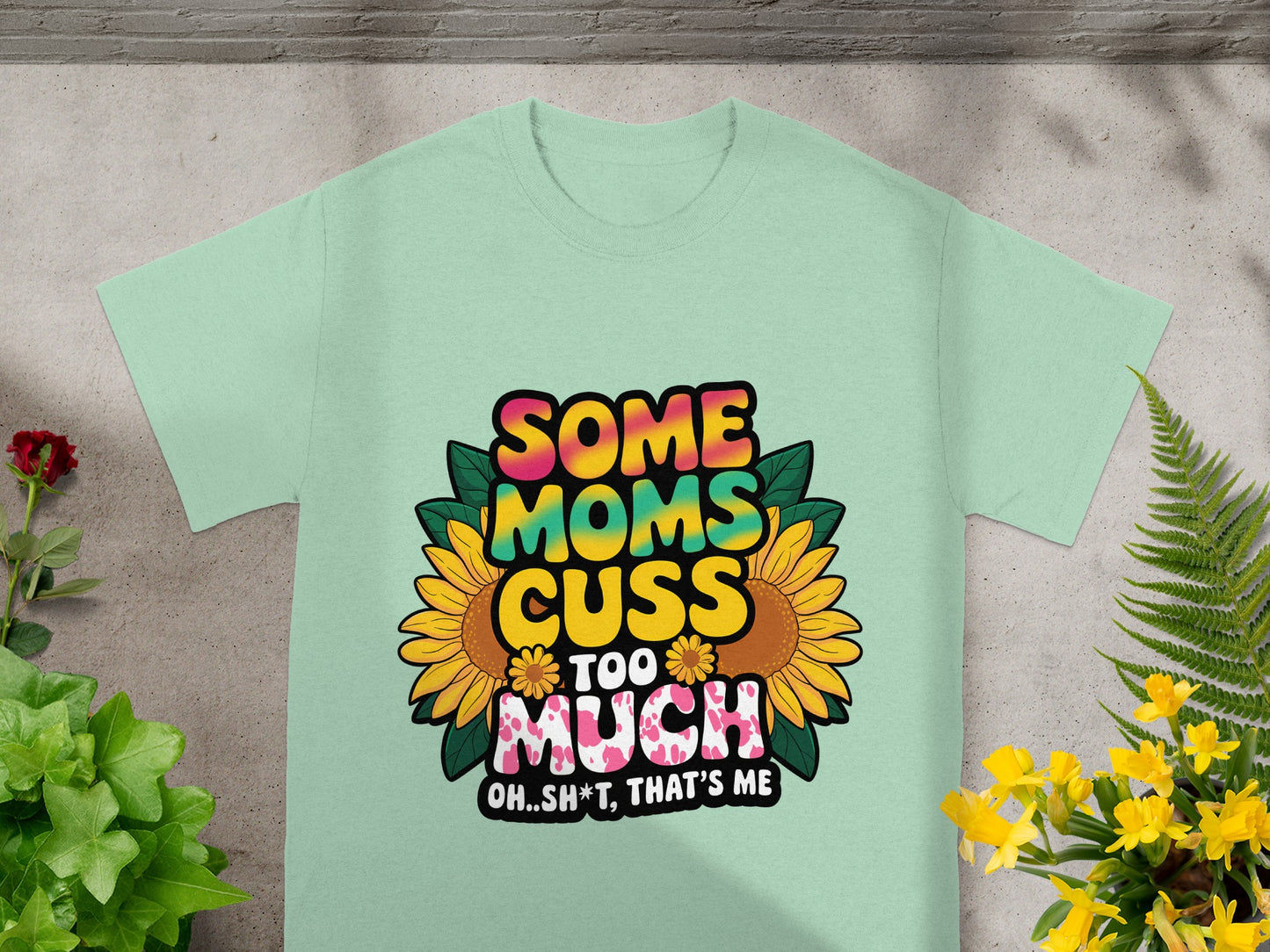 Light green t-shirt with "Some Moms Cuss Too Much" text and sunflowers.