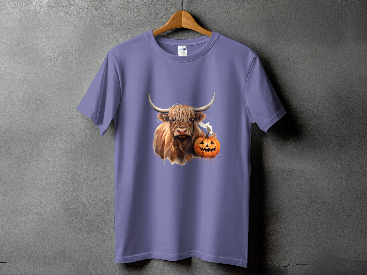Highland cow and jack-o'-lantern graphic on a purple t-shirt.