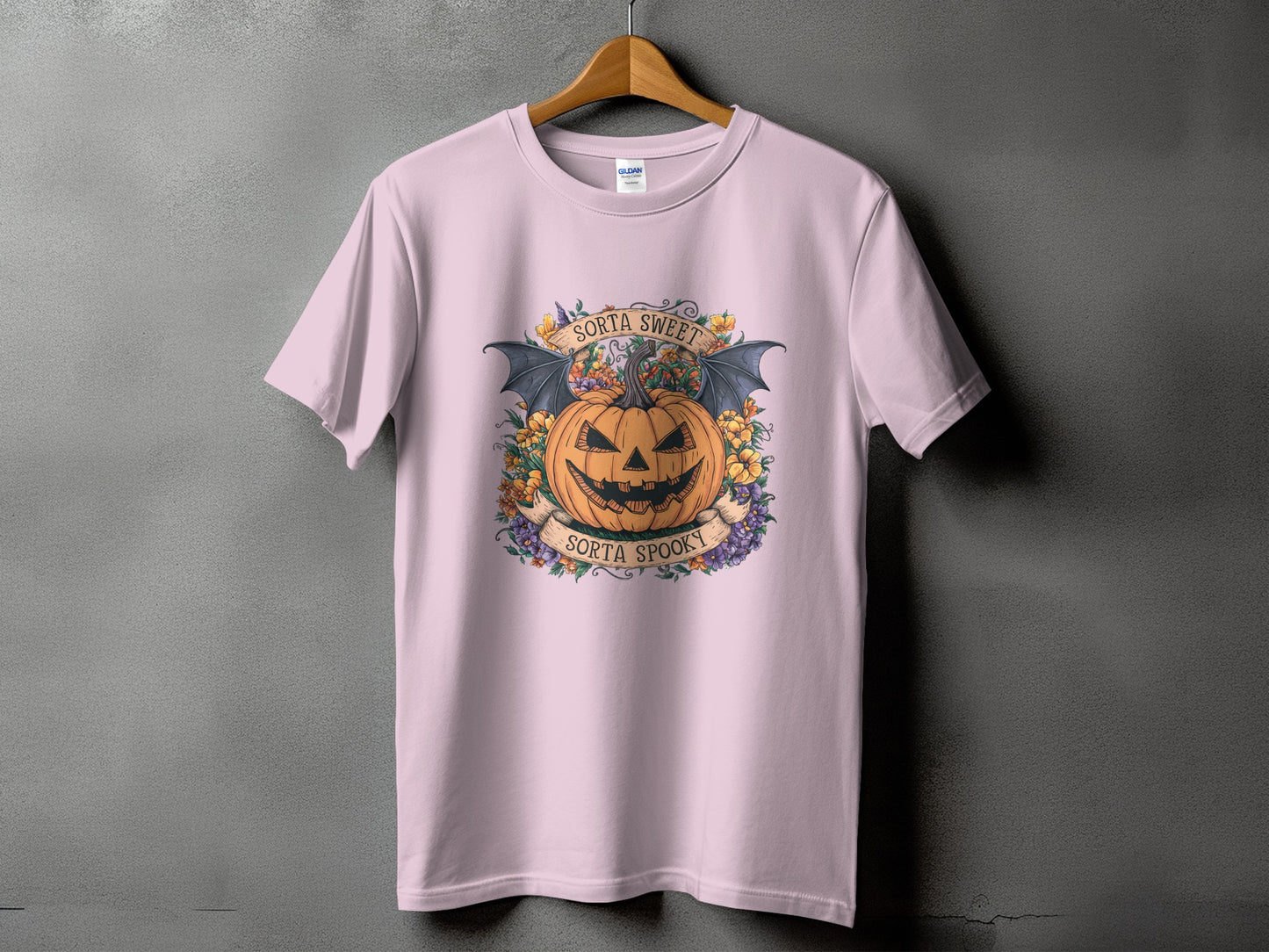 Pink t-shirt with a jack-o'-lantern and bats design that reads "Sorta Sweet" and "Sorta Spooky."