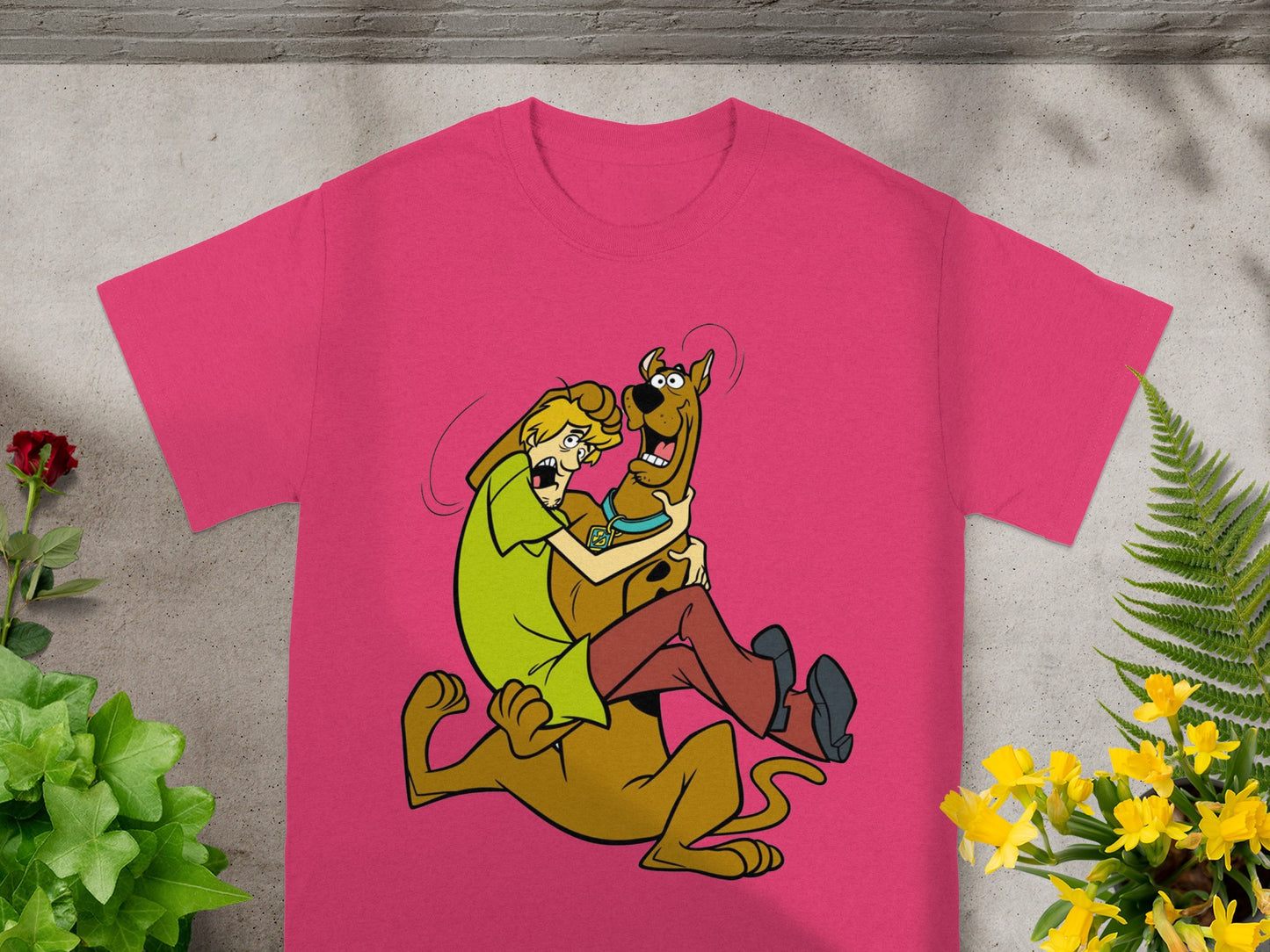 Scooby-Doo and Shaggy hugging on a pink t-shirt.