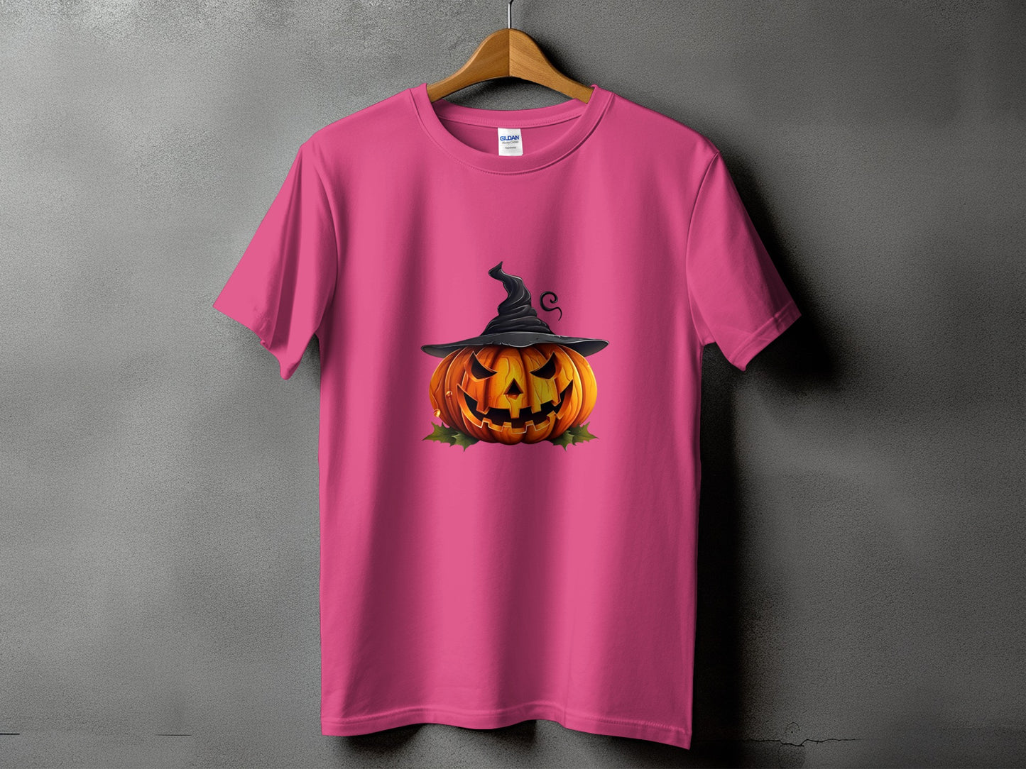 Pink t-shirt with a Jack-o'-lantern wearing a witch hat and leaves graphic.