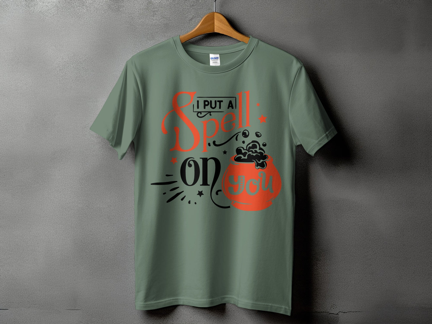 Green t-shirt with "I PUT A Spell ON YOU" and cauldron graphic.
