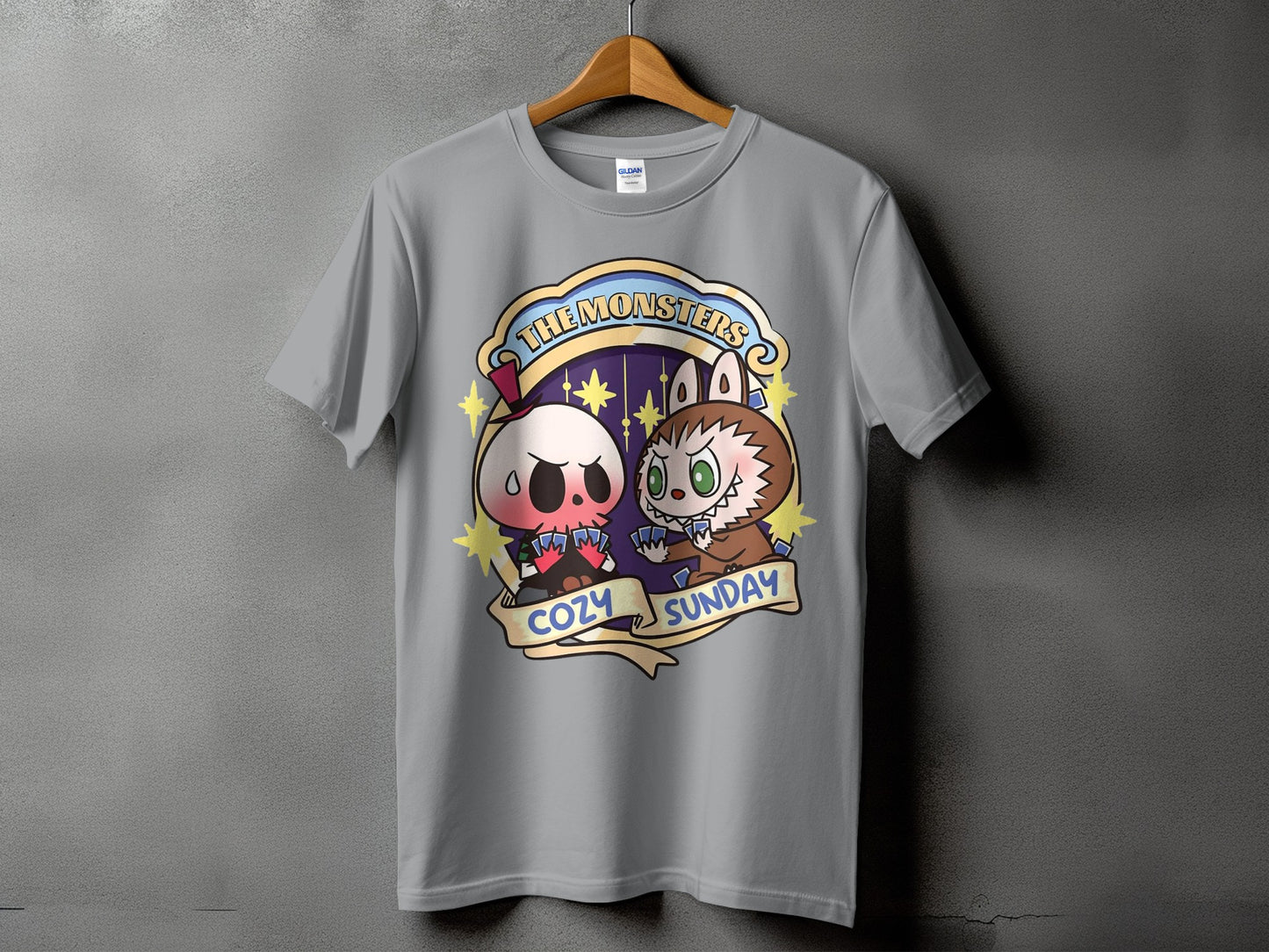 Gray t-shirt with cartoon skull and werewolf characters playing cards, text "The Monsters Cozy Sunday".