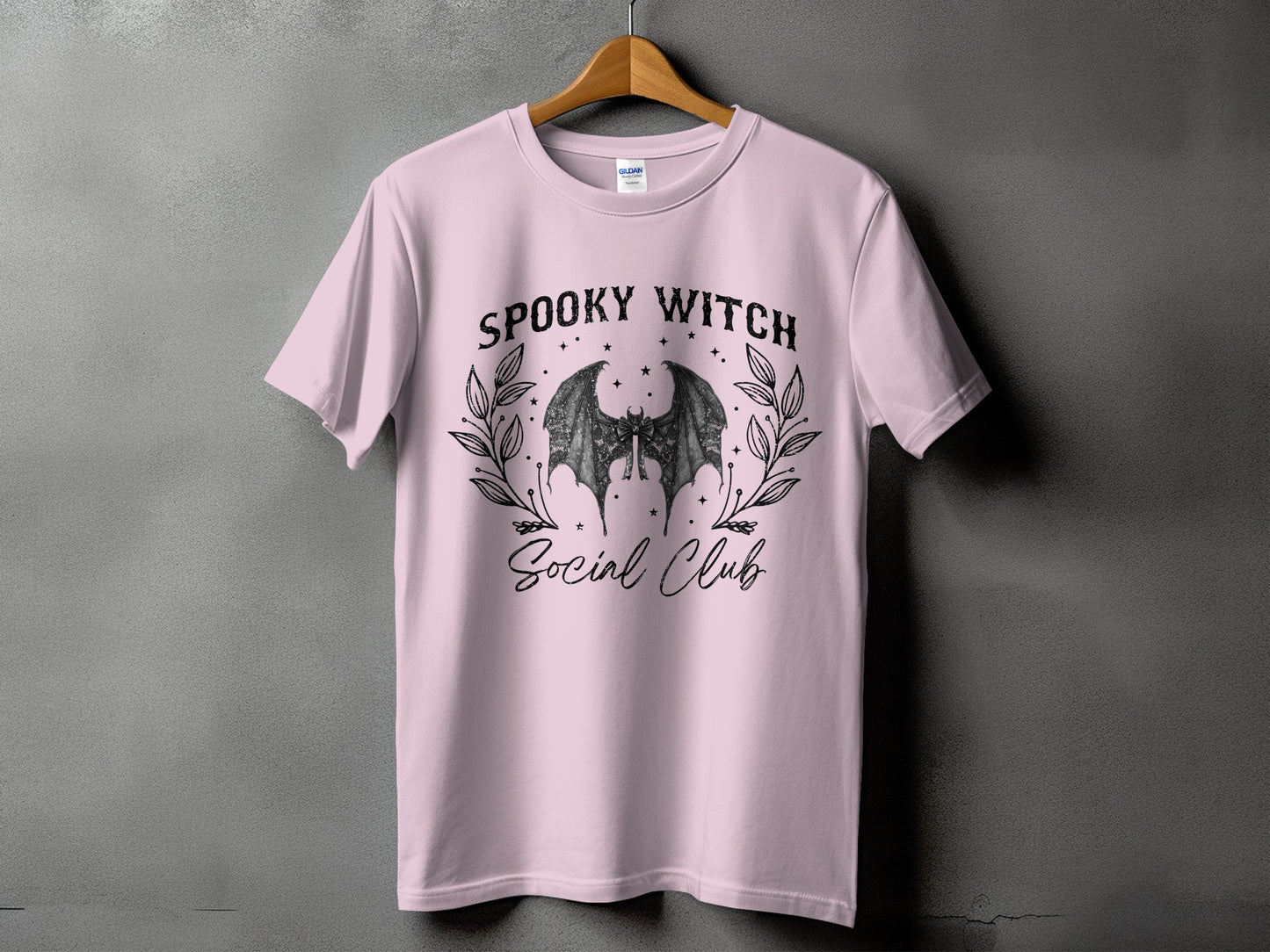 Pink t-shirt with "Spooky Witch Social Club" text and a bat graphic.