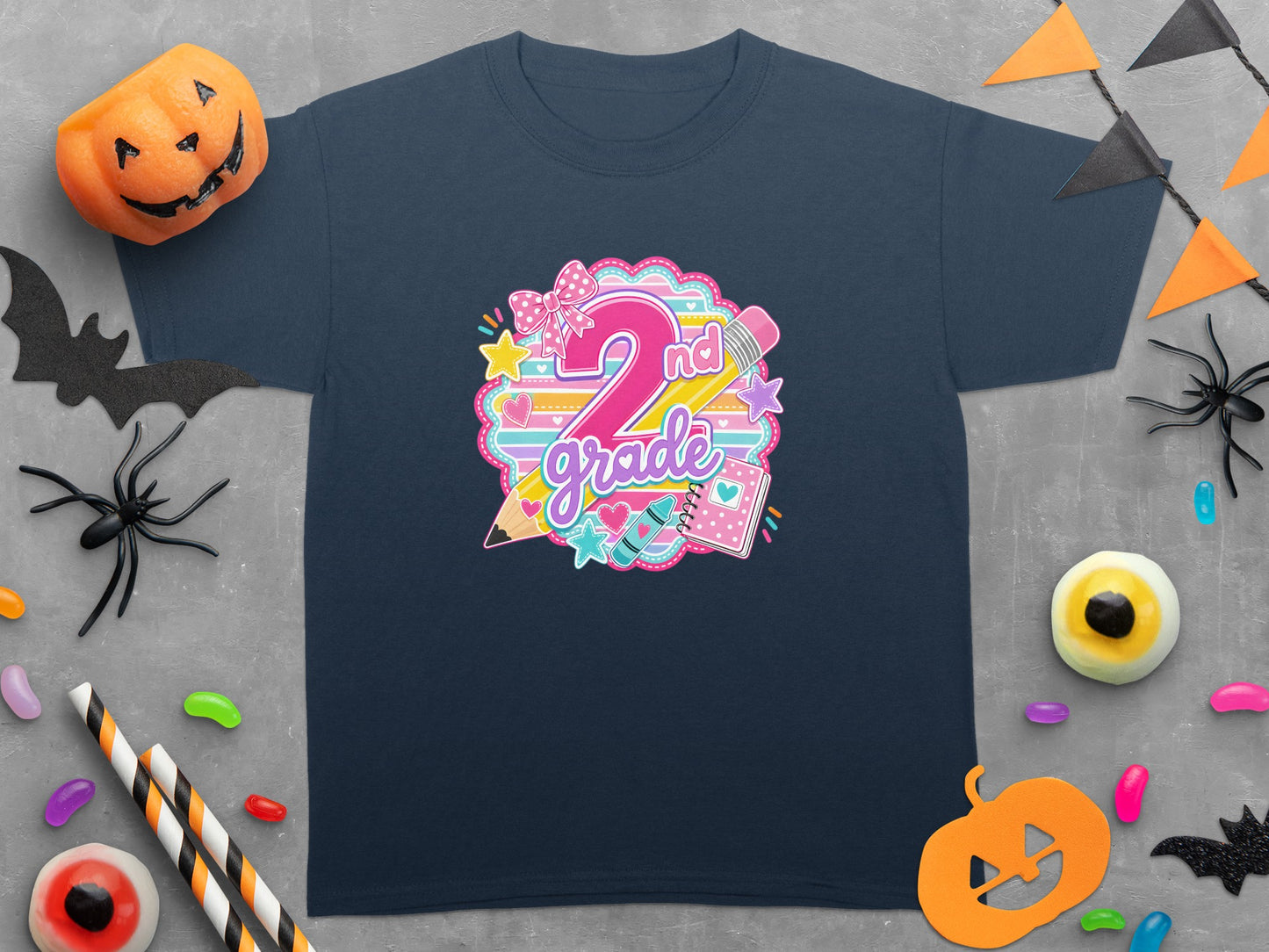 Navy t-shirt with "2nd grade" graphic featuring colorful school supplies and a bow.