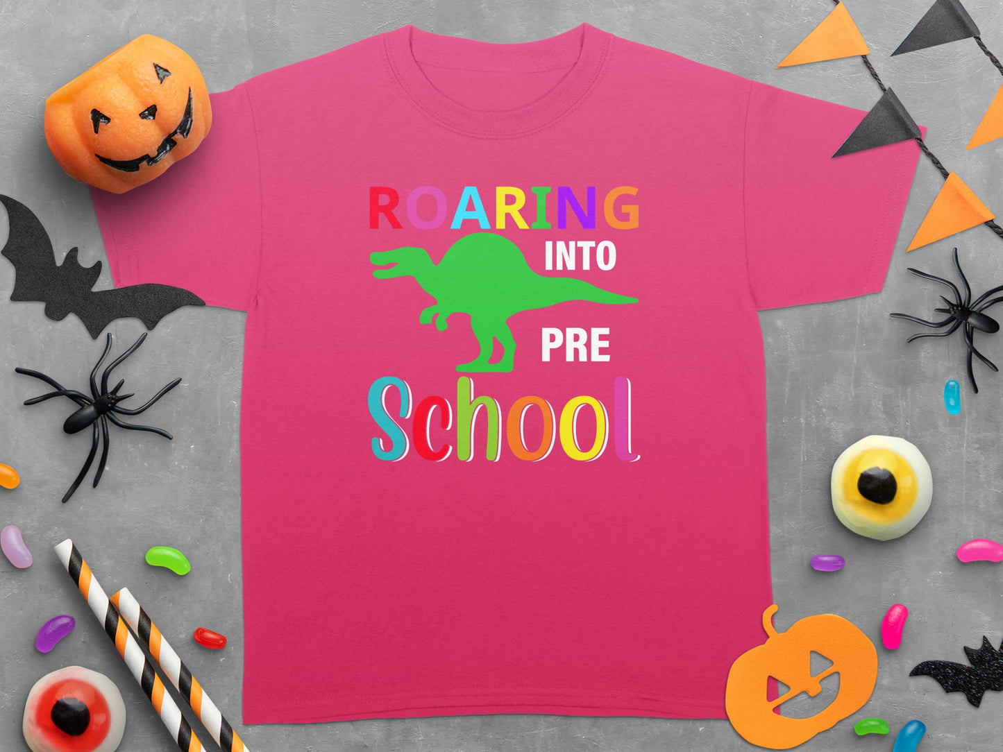 Pink t-shirt with "ROARING INTO PRE SCHOOL" text and a green dinosaur graphic.