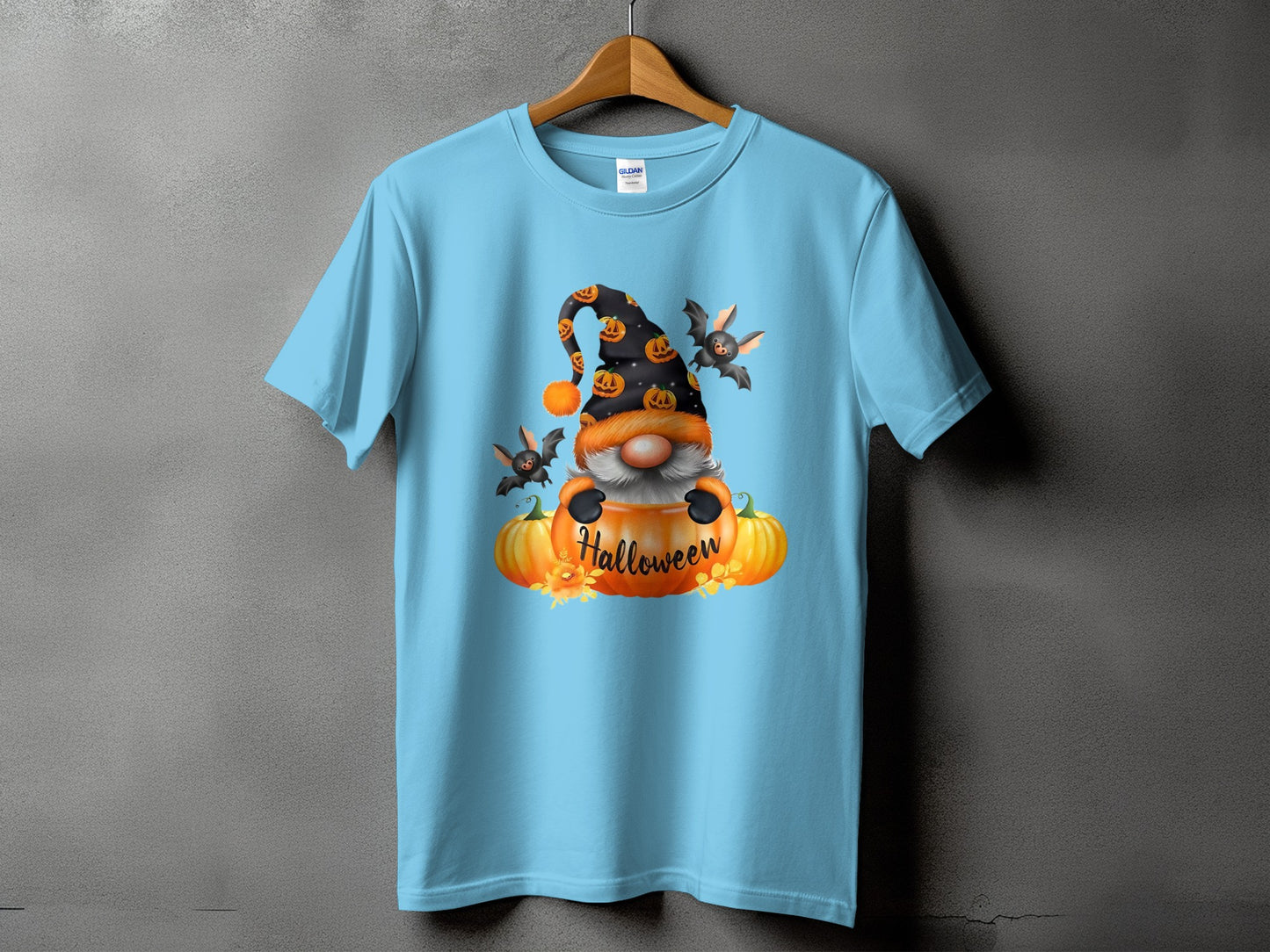 Light blue t-shirt with a Halloween gnome, pumpkins, bats, and "Halloween" text graphic.