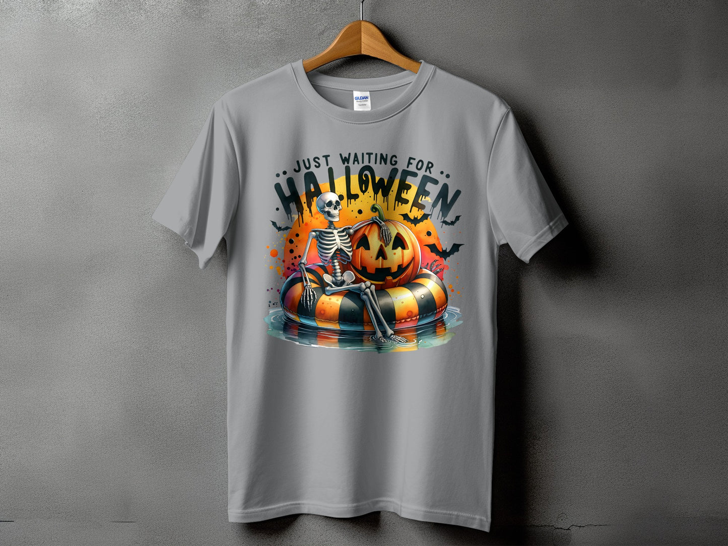Skeleton sitting on a pumpkin float with text "Just Waiting For Halloween".