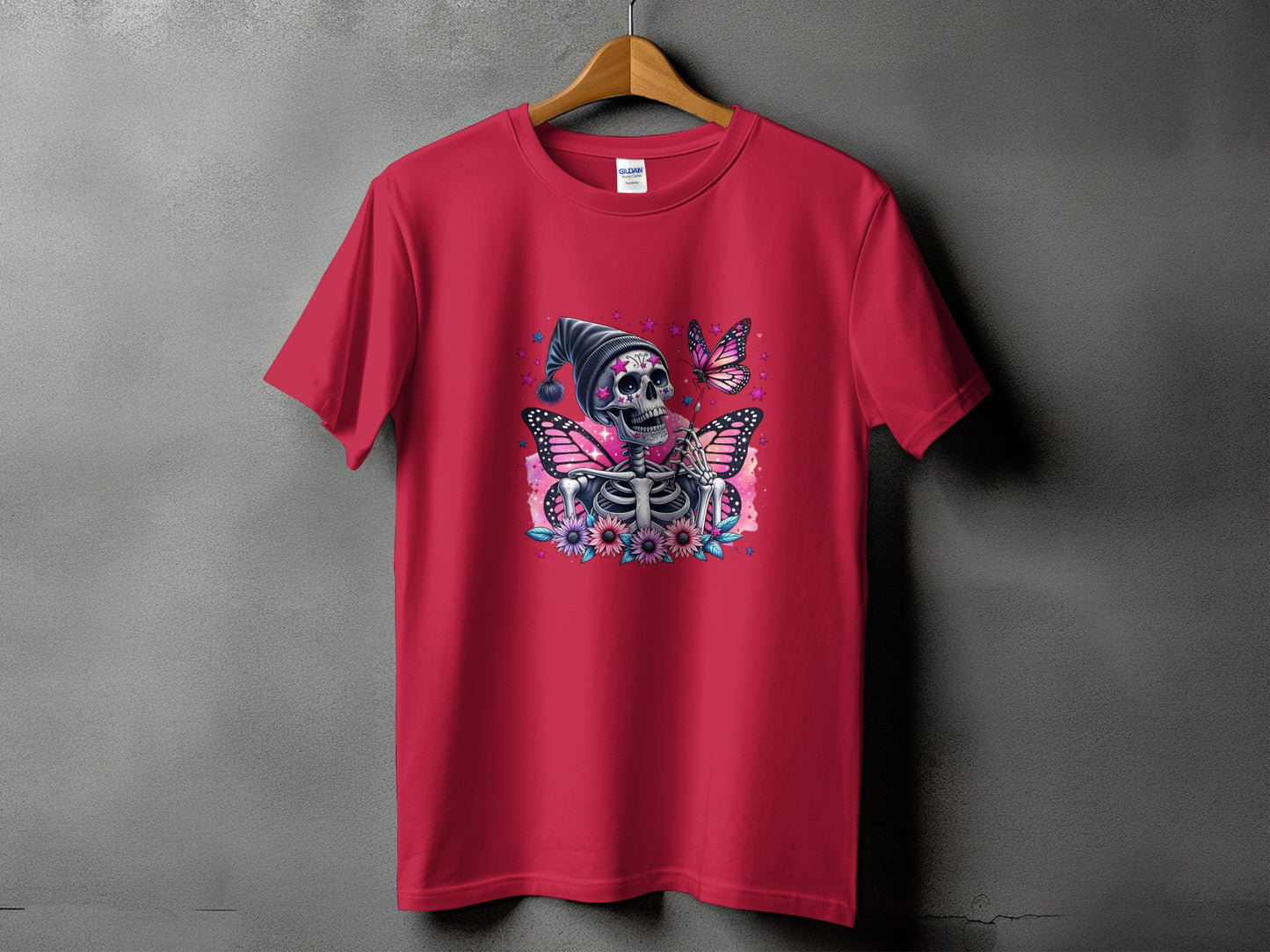 Red t-shirt with skeleton, butterflies, flowers, and stars graphic design.